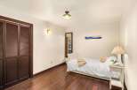 This cozy bedroom features a plush, inviting bed, perfect for relaxation.