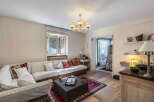 This charming living room features a comfortable sectional sofa, perfect for relaxing and entertaining.