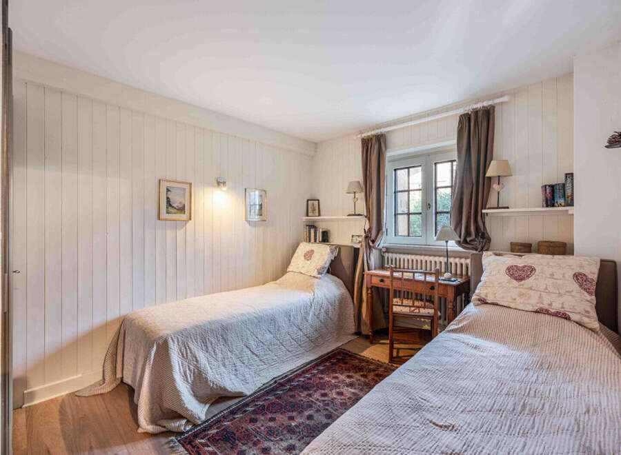 This charming bedroom features two twin beds, perfect for guests or a cozy shared space.