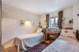 This charming bedroom features two twin beds, perfect for guests or a cozy shared space.