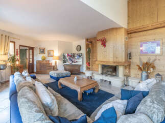 Step into luxury with this stunning living room, featuring a cozy fireplace and a plush blue sofa perfect for relaxation.