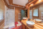 This stunning bathroom boasts a rustic charm with its wooden paneling and warm, inviting ambiance.