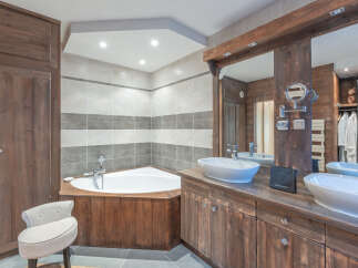 This luxurious bathroom boasts a rustic design with wooden accents and a modern touch.