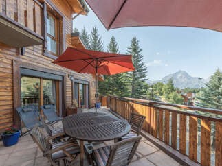 Enjoy breathtaking mountain views from this charming balcony.