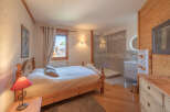 Experience the charm of this cozy bedroom, featuring a comfortable bed and a private bathroom.