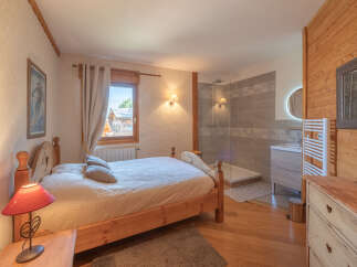 Experience the charm of this cozy bedroom, featuring a comfortable bed and a private bathroom.