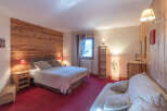 This cozy bedroom features a warm wooden accent wall, creating a rustic and inviting atmosphere.