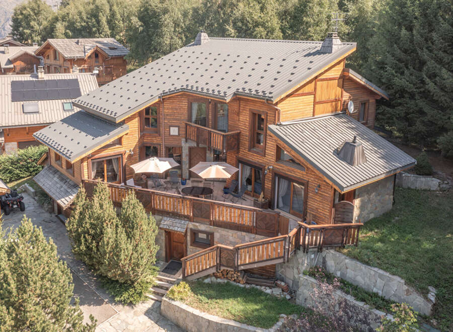 Discover the charm of this stunning wooden chalet, nestled in a serene, tree-lined setting.