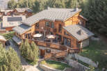Discover the charm of this stunning wooden chalet, nestled in a serene, tree-lined setting.