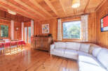 Step into this charming cabin retreat, where natural light floods the space, highlighting the warm wooden interiors.