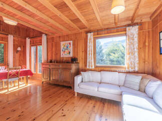 Step into this charming cabin retreat, where natural light floods the space, highlighting the warm wooden interiors.