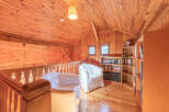 This cozy loft space features beautiful wooden paneling throughout, creating a warm and inviting atmosphere.
