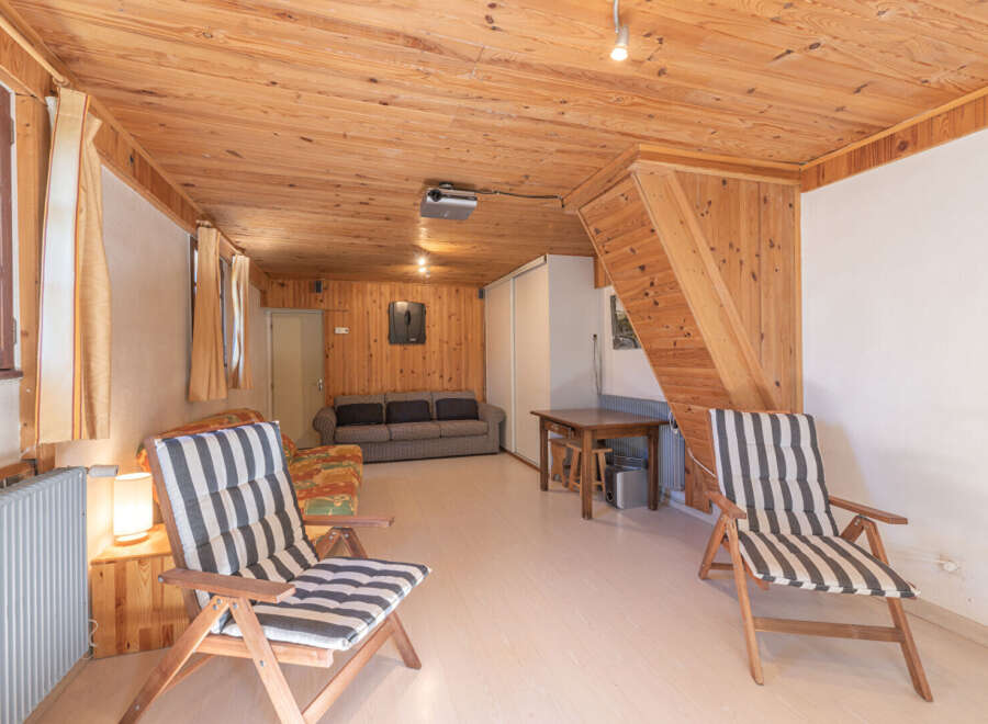 This cozy living space features a warm, inviting atmosphere with its wooden paneling and flooring.