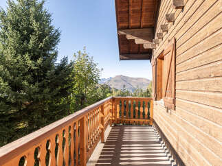 Enjoy breathtaking mountain views from this charming wooden balcony.