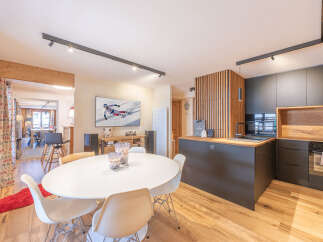 Experience modern living in this stunning property, featuring a stylish kitchen with sleek cabinetry and a cozy dining area perfect for entertaining.