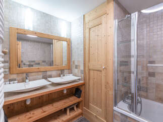 This stunning bathroom features a modern design with a touch of rustic charm.