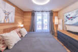 Experience the charm of this cozy bedroom, featuring a comfortable bed and a stylish deer artwork.