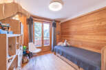 This charming bedroom features a cozy wooden interior, creating a warm and inviting atmosphere.