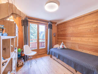 This charming bedroom features a cozy wooden interior, creating a warm and inviting atmosphere.