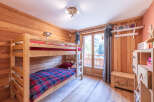 This charming bedroom features a cozy bunk bed, perfect for a family or group of friends.