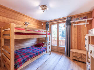 This charming bedroom features a cozy bunk bed, perfect for a family or group of friends.