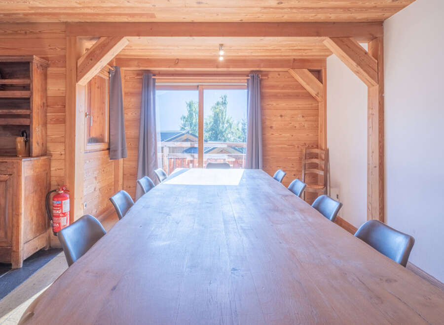 This stunning dining room features a large wooden table perfect for gatherings.