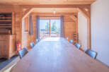This stunning dining room features a large wooden table perfect for gatherings.