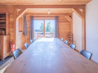This stunning dining room features a large wooden table perfect for gatherings.