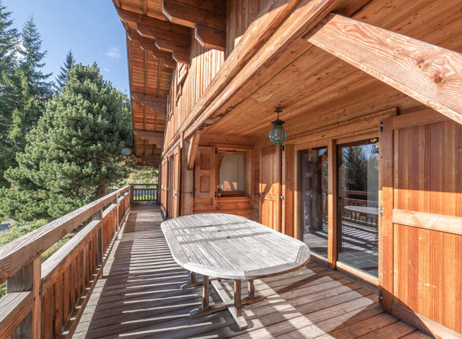 Enjoy the tranquility of this stunning wooden chalet, featuring a spacious deck perfect for outdoor dining and relaxation.