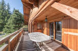 Enjoy the tranquility of this stunning wooden chalet, featuring a spacious deck perfect for outdoor dining and relaxation.