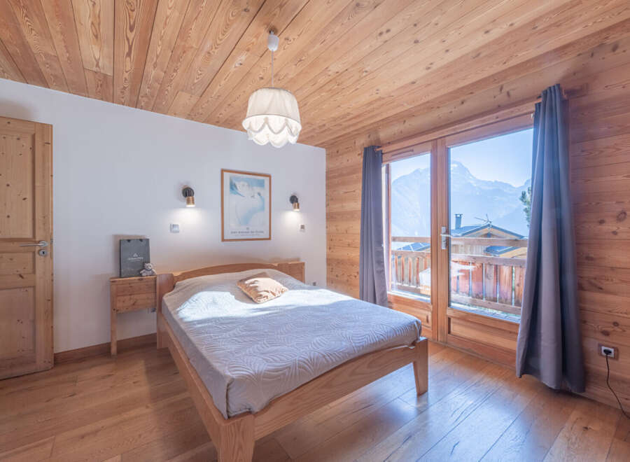 Experience the warmth of this cozy bedroom, featuring stunning wooden accents throughout.