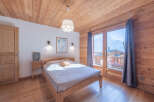Experience the warmth of this cozy bedroom, featuring stunning wooden accents throughout.