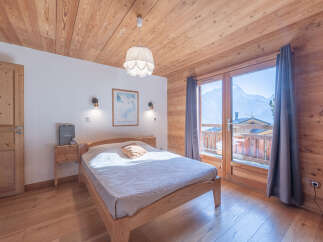 Experience the warmth of this cozy bedroom, featuring stunning wooden accents throughout.