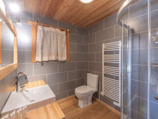 This charming bathroom features a modern design with a touch of rustic elegance.