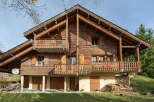 This stunning wooden chalet offers a warm and inviting atmosphere, perfect for a mountain retreat.