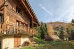 Discover the charm of this stunning wooden chalet nestled in a picturesque mountain setting.