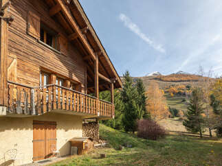 Discover the charm of this stunning wooden chalet nestled in a picturesque mountain setting.