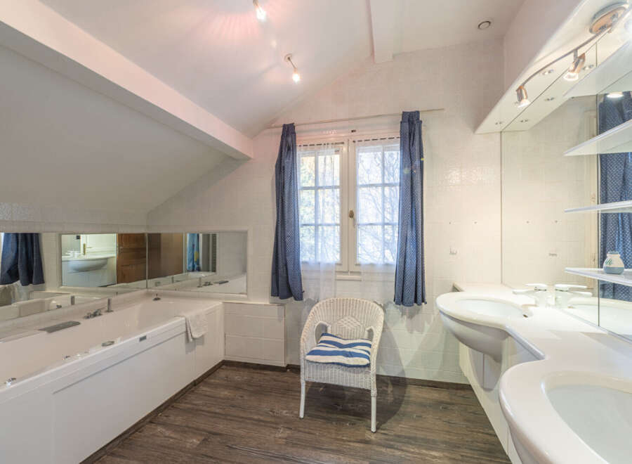 Step into a luxurious bathroom retreat! This space features a sleek, modern design with a jacuzzi tub, perfect for unwinding after a long day.