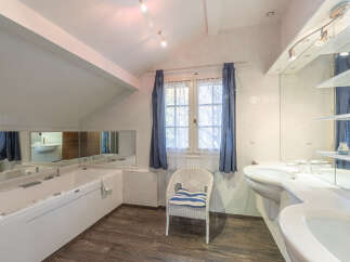 Step into a luxurious bathroom retreat! This space features a sleek, modern design with a jacuzzi tub, perfect for unwinding after a long day.