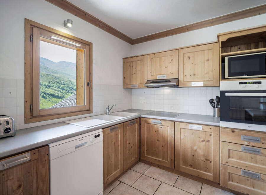 This charming kitchen boasts a warm, inviting atmosphere with its natural wood cabinetry and ample counter space.