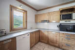 This charming kitchen boasts a warm, inviting atmosphere with its natural wood cabinetry and ample counter space.