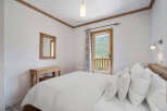 This cozy bedroom features a comfortable bed with plush pillows, perfect for a relaxing retreat.