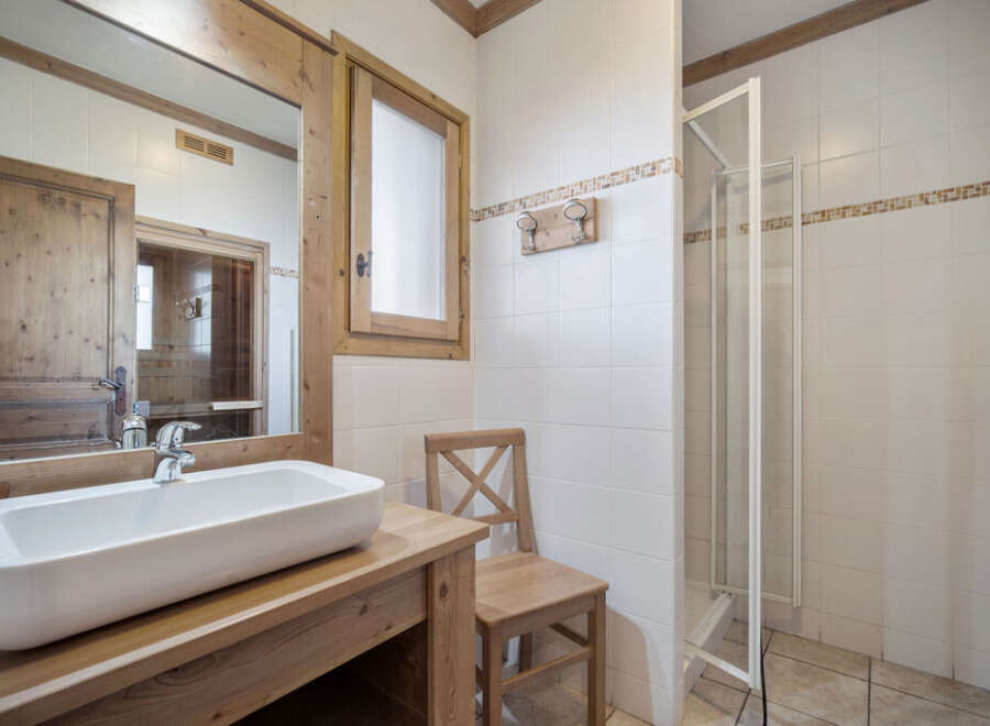This charming bathroom features a rustic design with wooden accents and a modern touch.