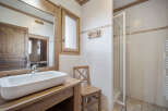 This charming bathroom features a rustic design with wooden accents and a modern touch.