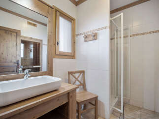 This charming bathroom features a rustic design with wooden accents and a modern touch.