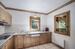 This charming kitchen features wooden cabinetry and a bright, airy feel.