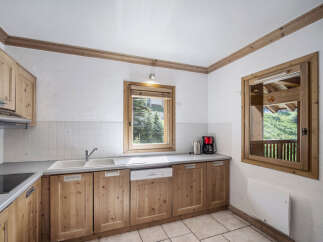 This charming kitchen features wooden cabinetry and a bright, airy feel.