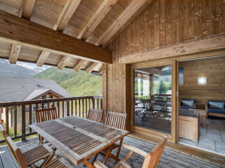 Enjoy breathtaking mountain views from this charming wooden balcony.