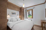 Experience the charm of this cozy bedroom, featuring a comfortable bed and ample natural light.