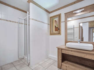 This stunning bathroom features a modern design with a touch of rustic charm.